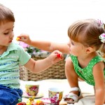 Caucasian little boy and girl eating sweets